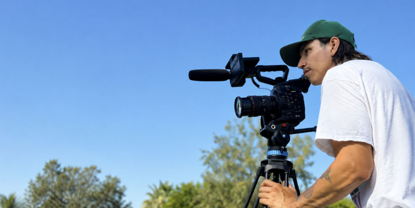 Streetlights student holding a professional video camera during a hands-on filmmaking workshop.